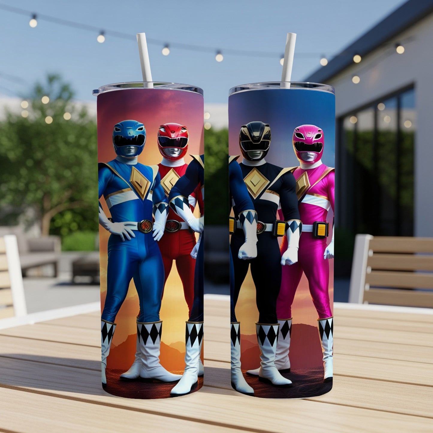 Two Mighty Morphin Power Rangers tumblers on a table with a sunset background.