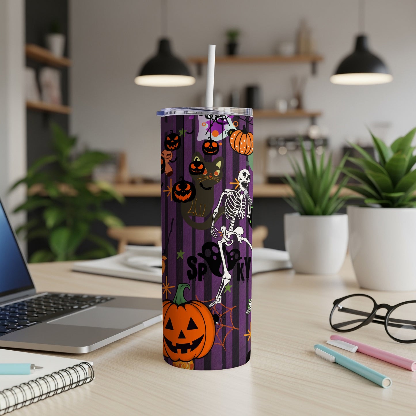 Tumbler with purple stripes and Halloween icons: skeleton, black cat, and pumpkins.