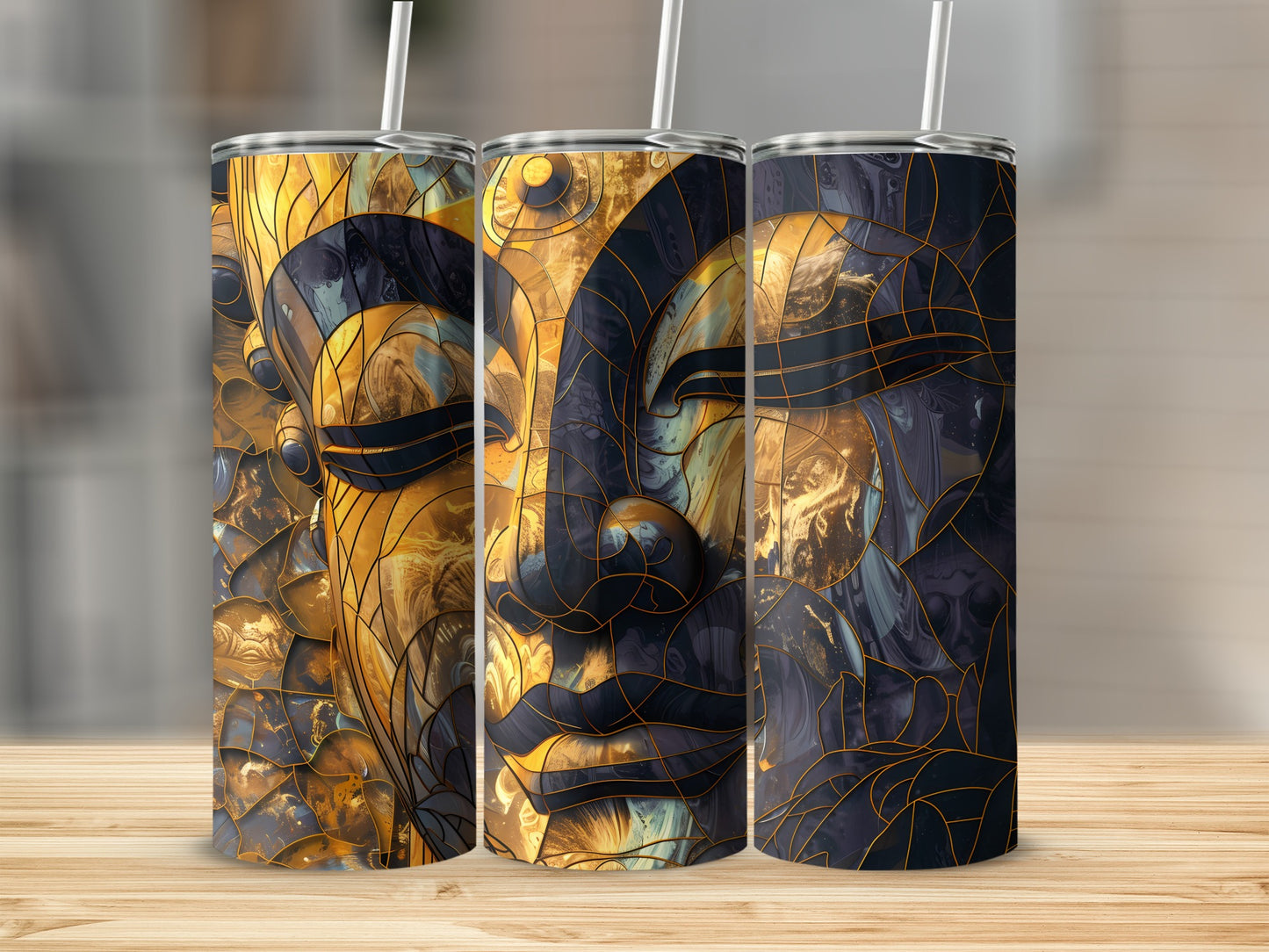 Three tumblers with abstract golden Buddha face design.