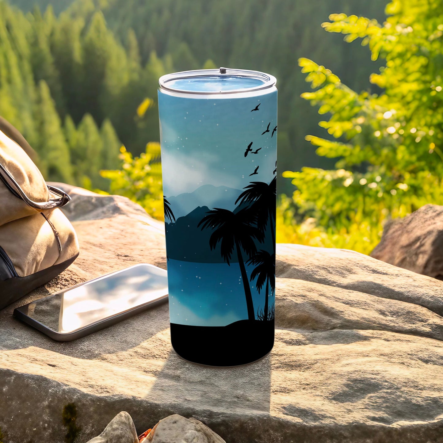 Tumbler with silhouette of palm trees, mountains, and birds against a starry sky.