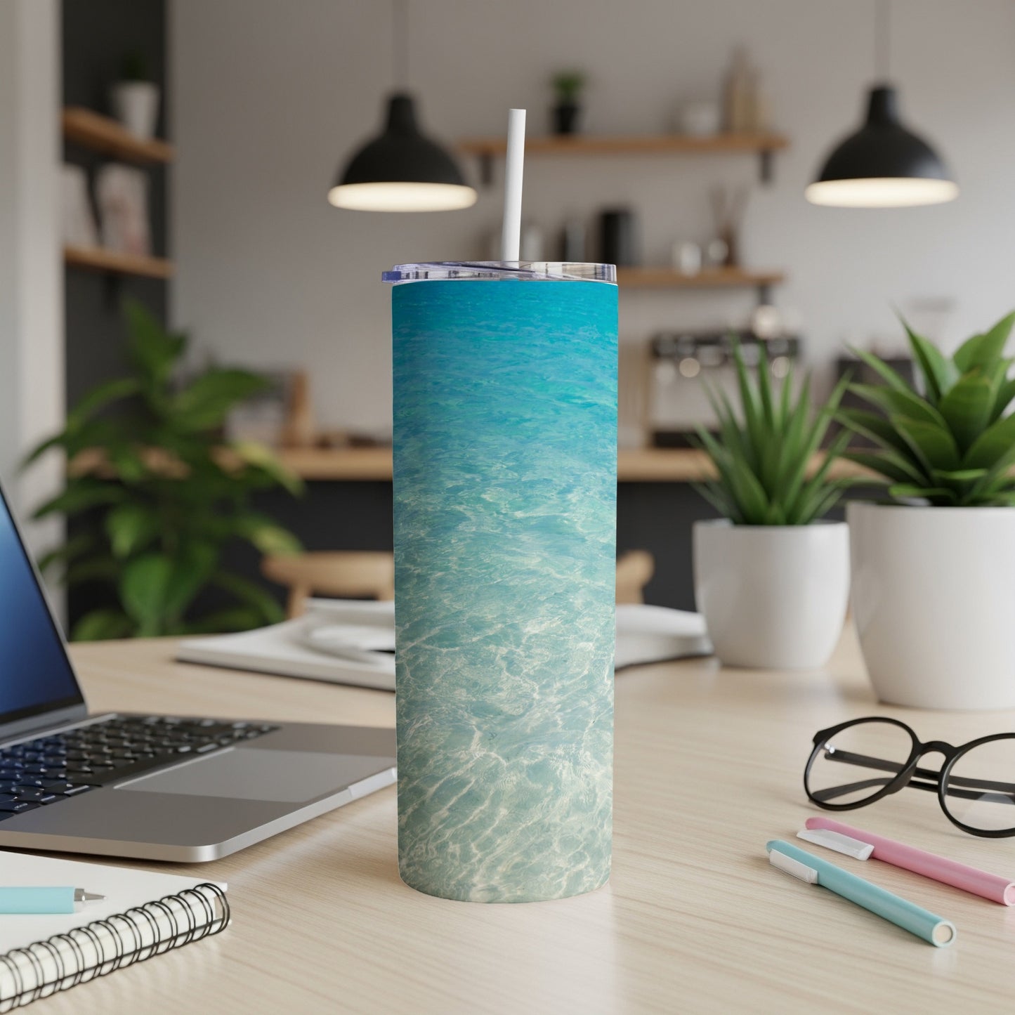 Blue ocean water texture on a white skinny tumbler with a straw.