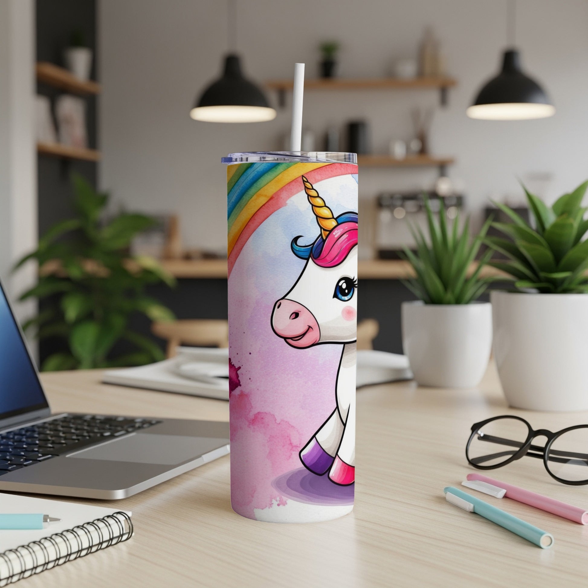 Unicorn with rainbow mane on a pink watercolor background, on a desk.