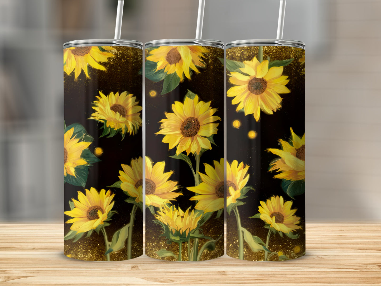 Three tumblers with a repeating sunflower design on a dark, sparkling background.