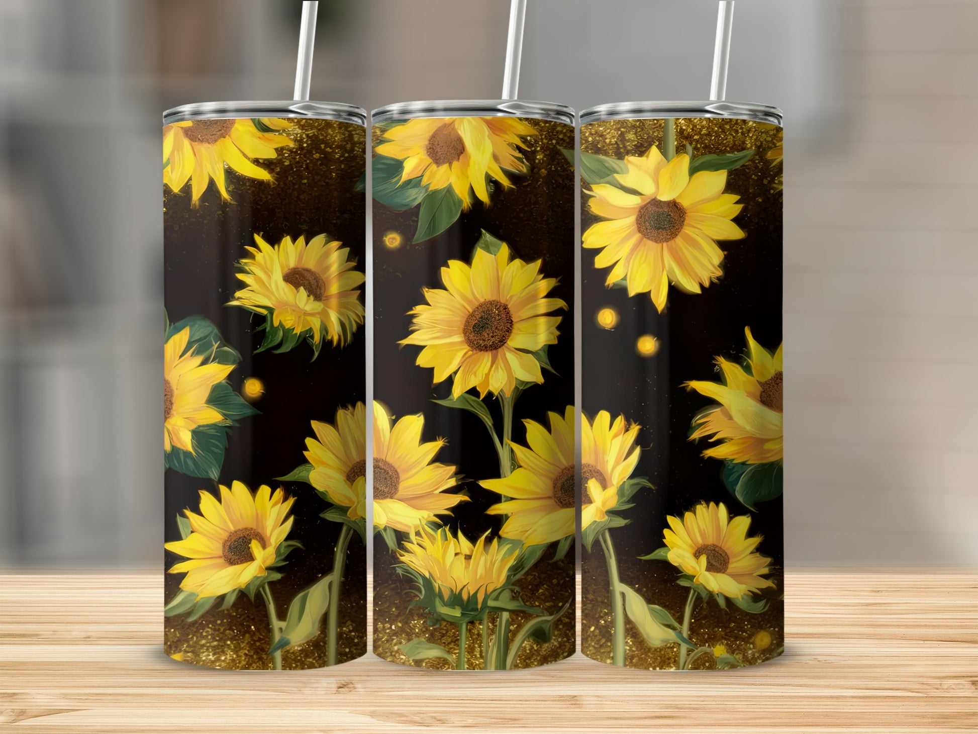 Three tumblers with a repeating sunflower design on a dark, sparkling background.