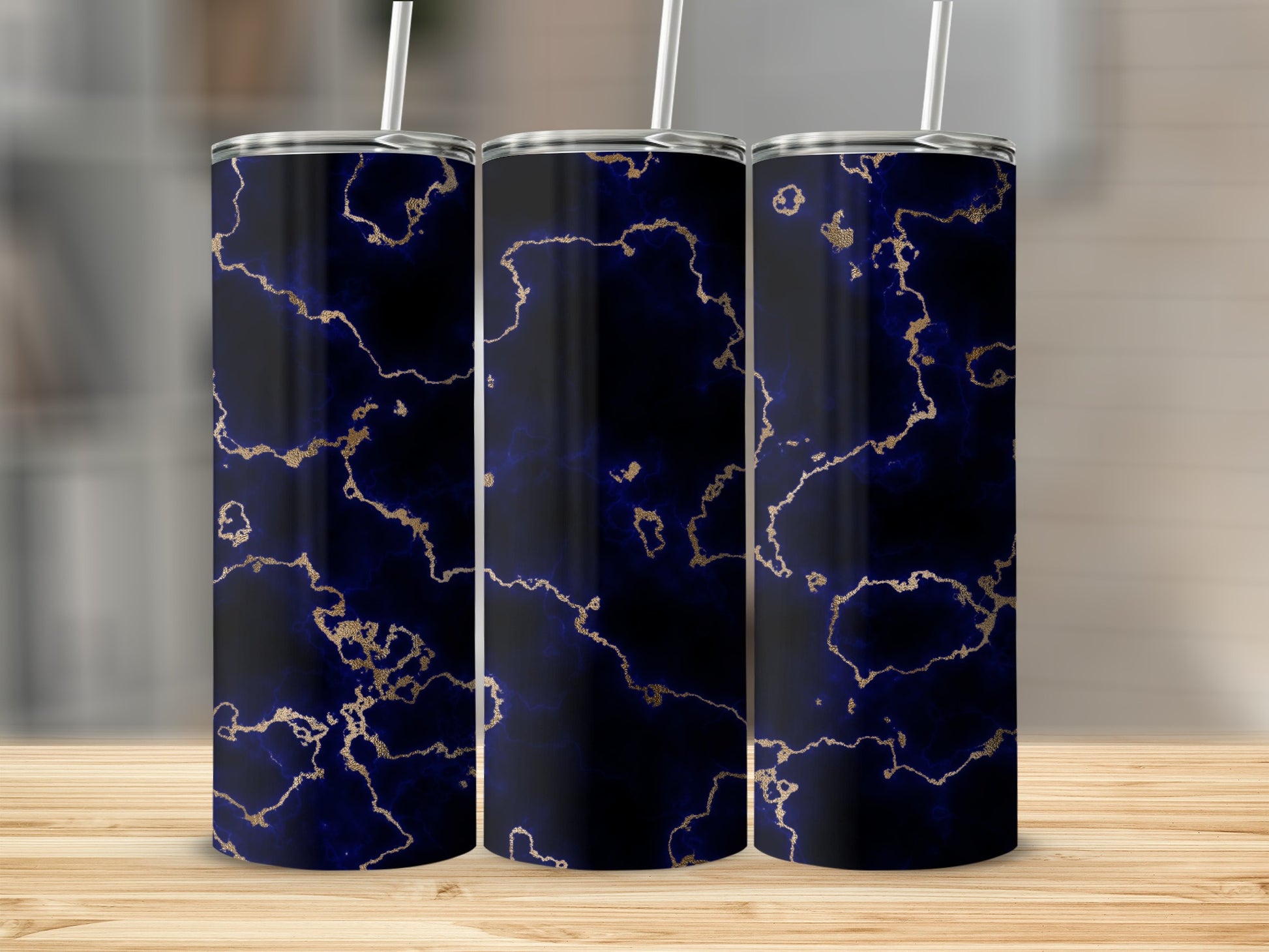 Three tumblers with a dark blue and gold marble pattern.