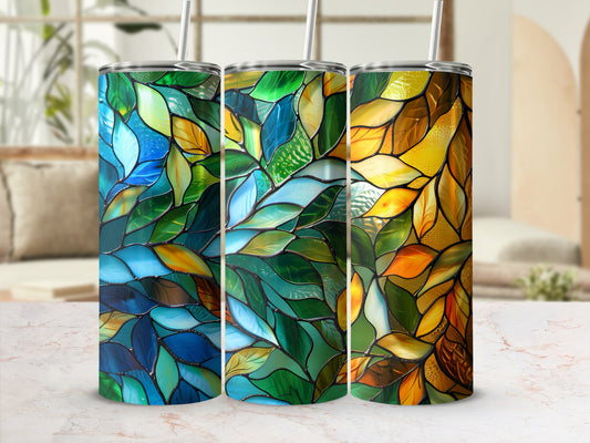 Three stained glass tumblers with leaf patterns in blue, green, and yellow.