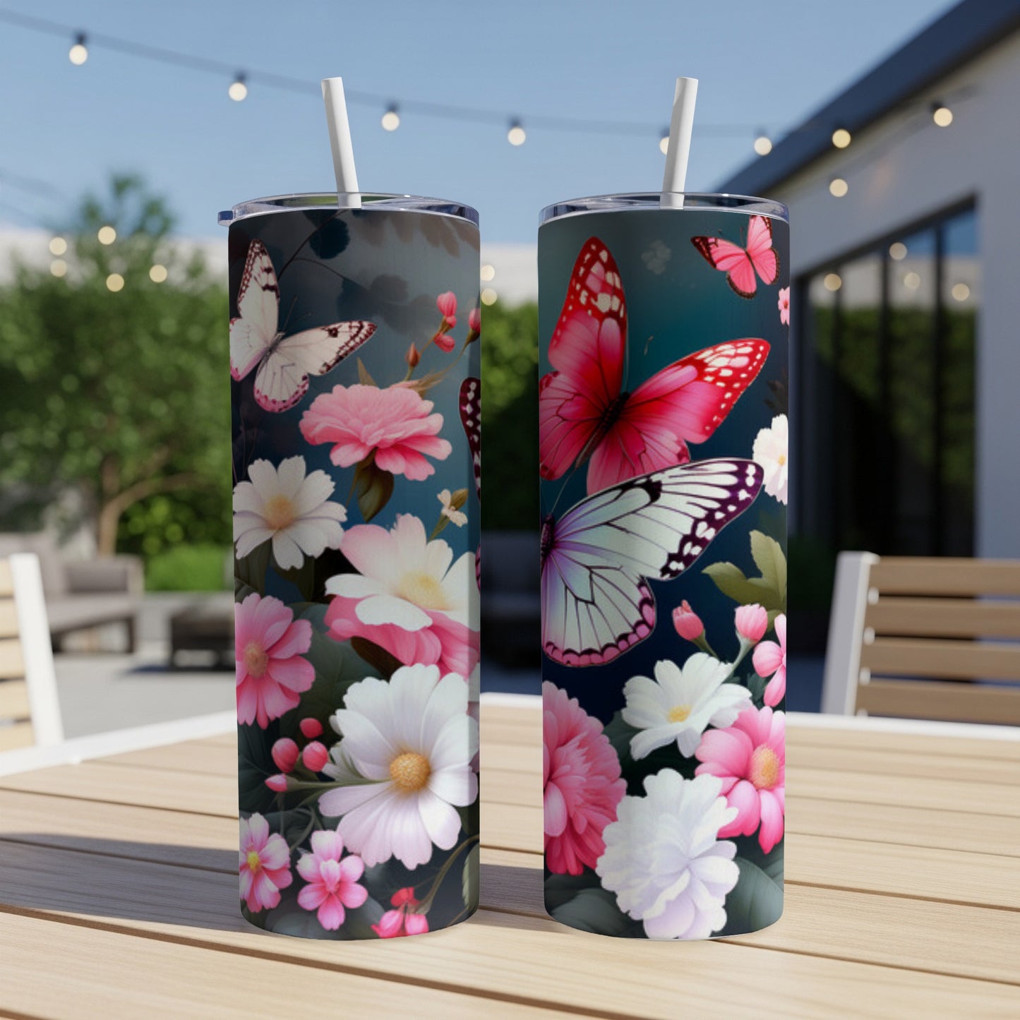Two tumblers with floral and butterfly designs on a table.