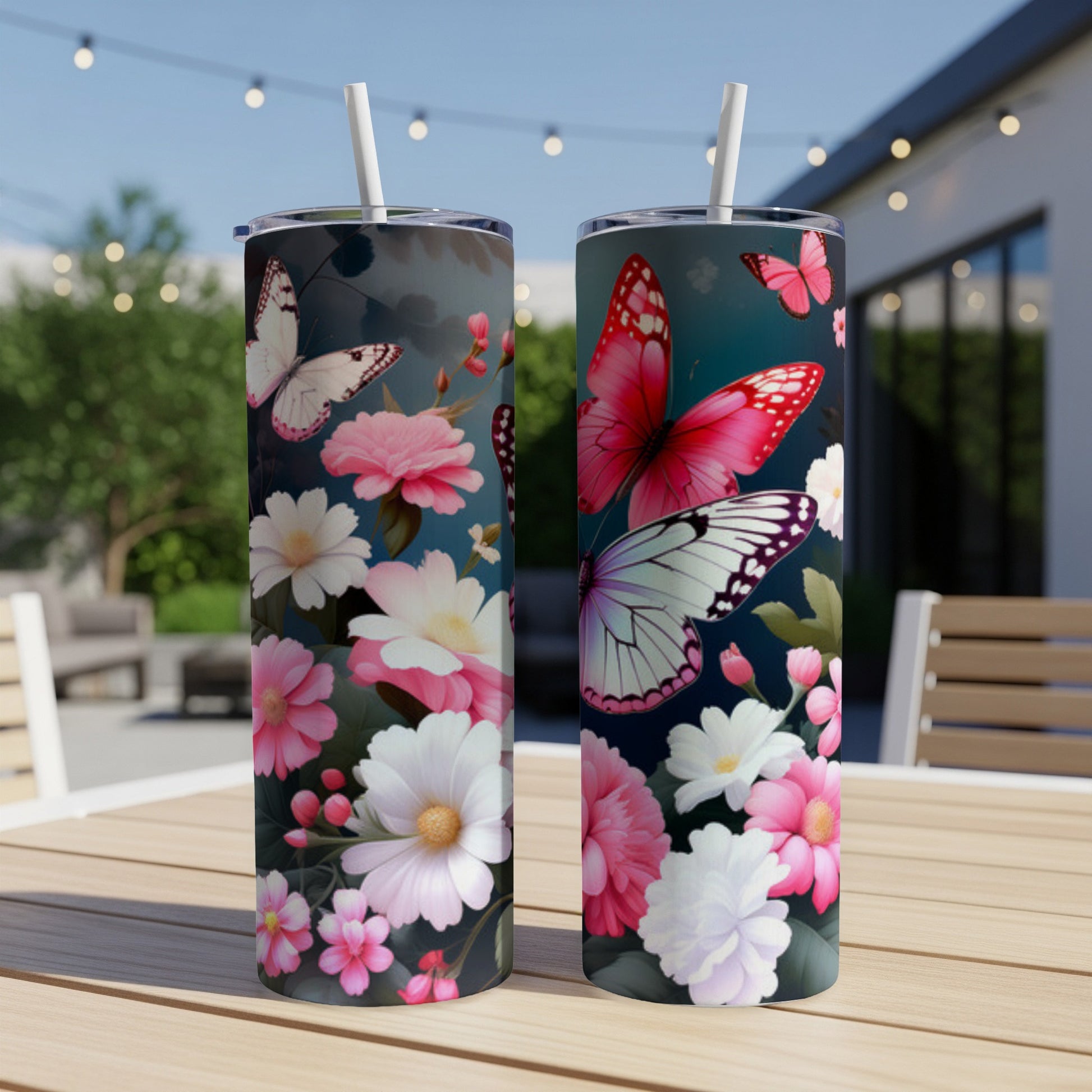 Two tumblers with floral and butterfly designs on a table.