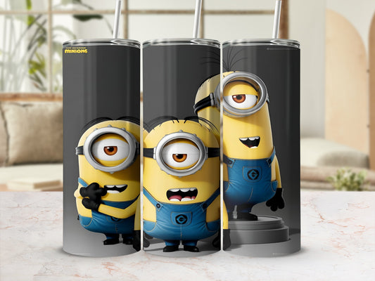 Three Minions from Despicable Me in blue overalls, smiling and holding straws.