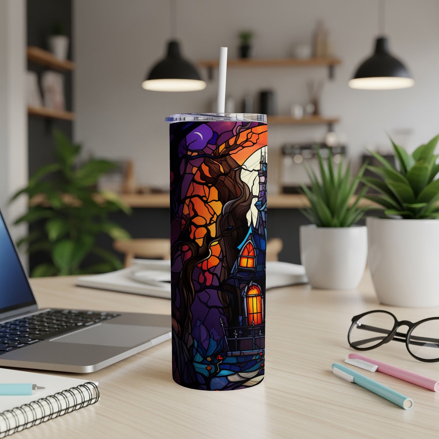 Stained glass tumbler with haunted house and moon design.