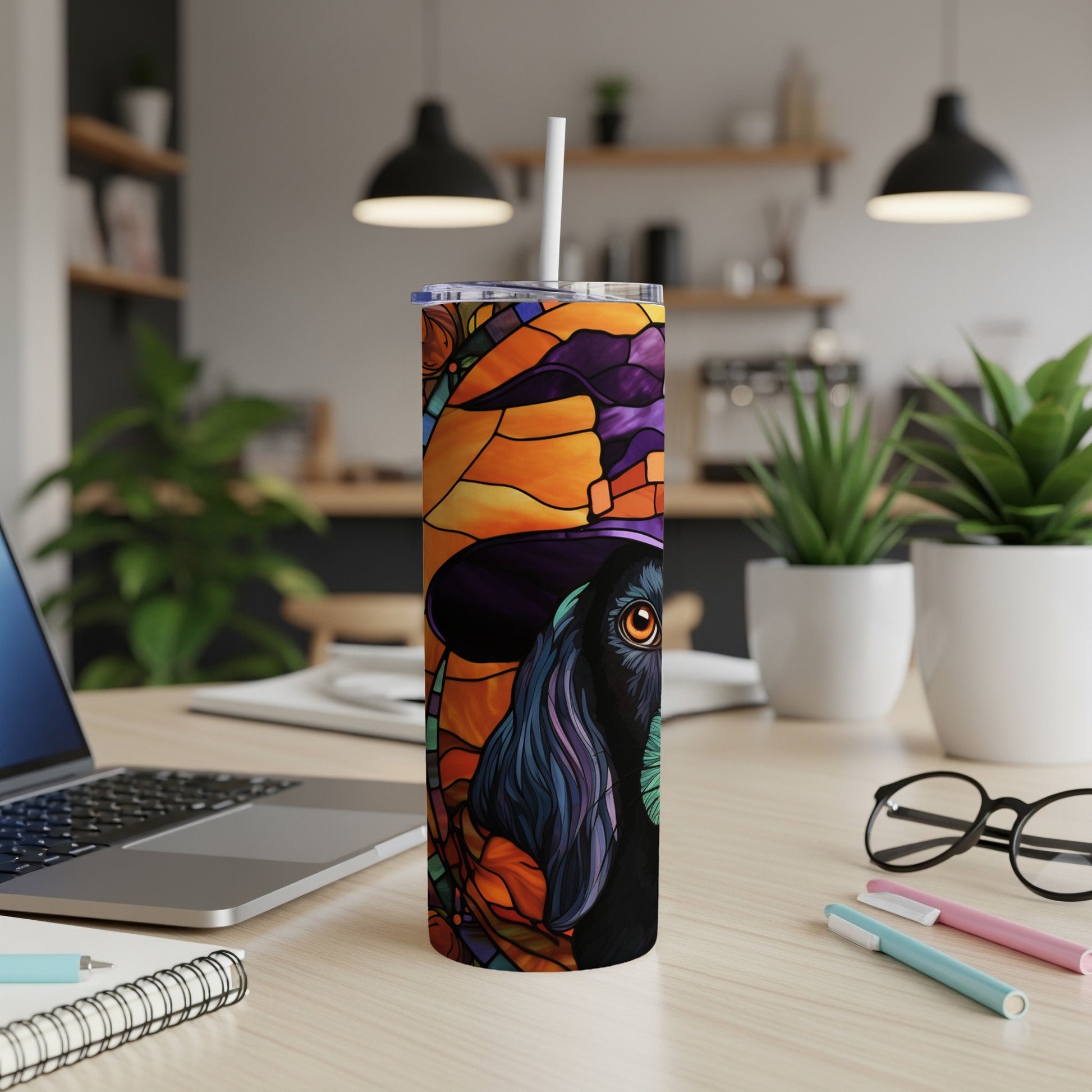 Black dog in witch hat with stained glass design on a tumbler.