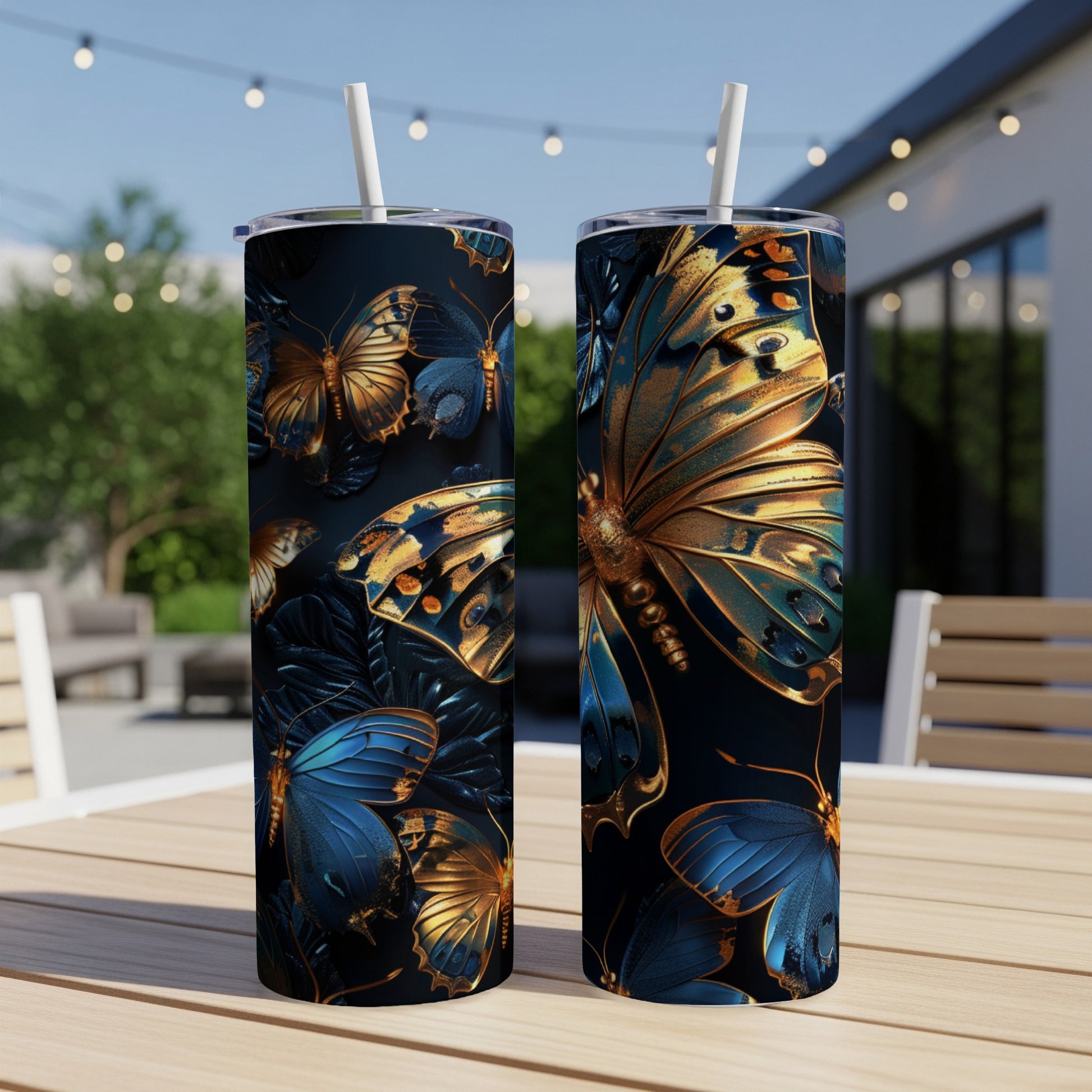 Two tall tumblers featuring golden and blue butterflies on a dark background.