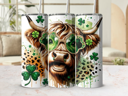 Highland cow wearing shamrock sunglasses, with green splatters and leopard print accents.