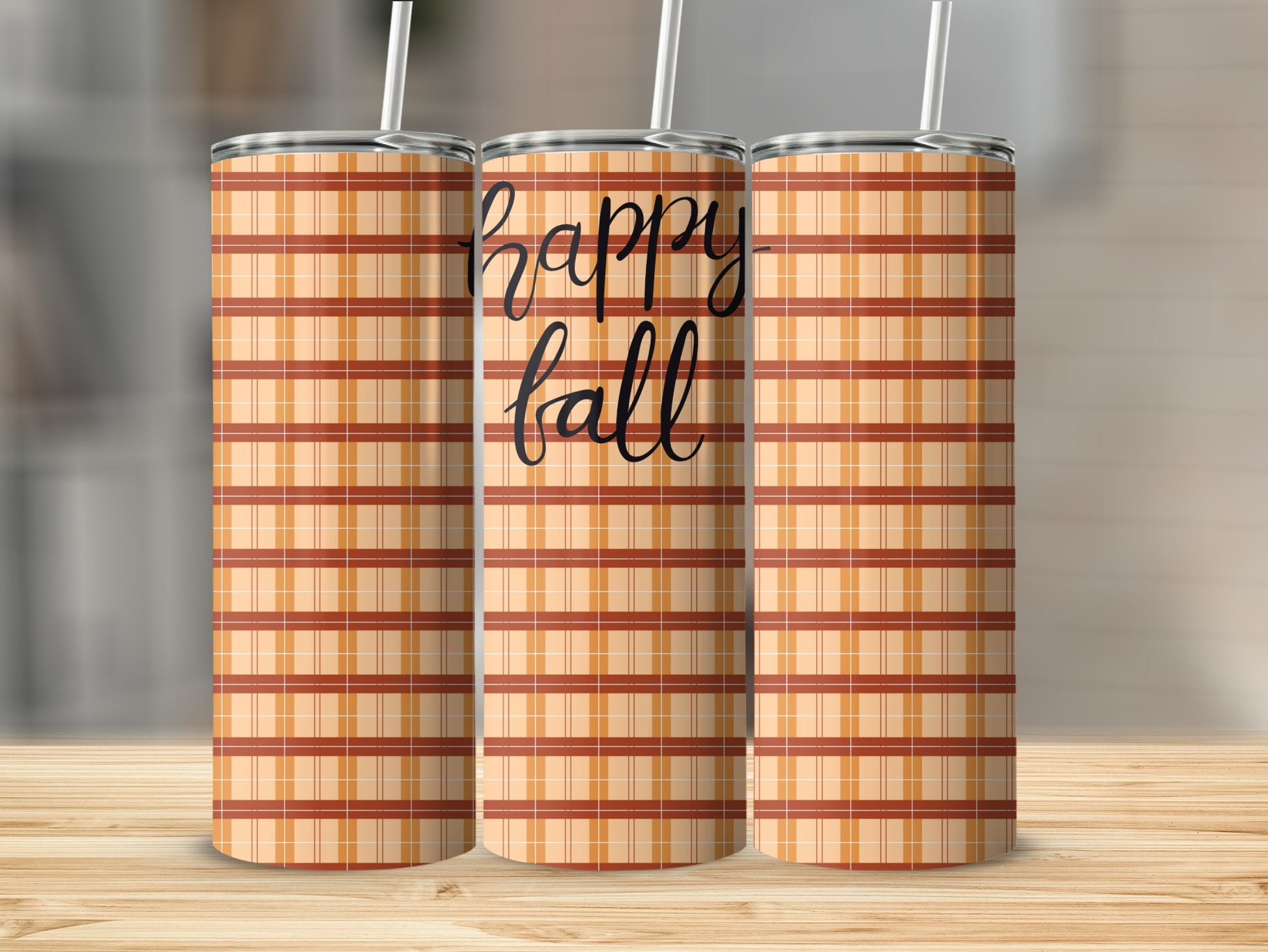 Three tumblers with plaid pattern and "happy fall" text.