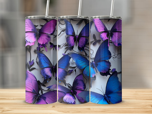 Three tumblers with purple and blue butterflies and floral accents.