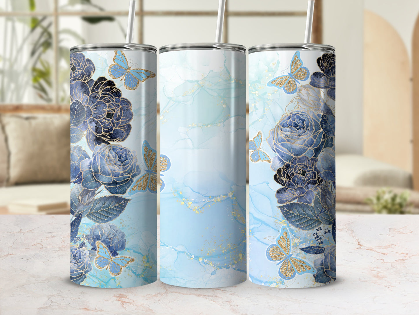 Three tumblers with blue floral and butterfly designs on a light blue watercolor background.