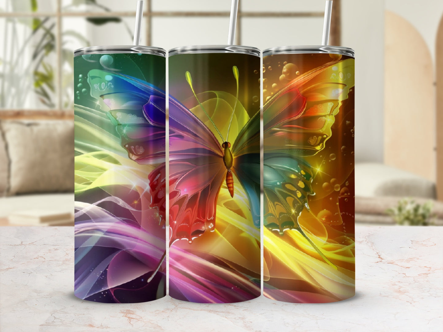 Three tumblers with vibrant butterfly and abstract colorful designs.