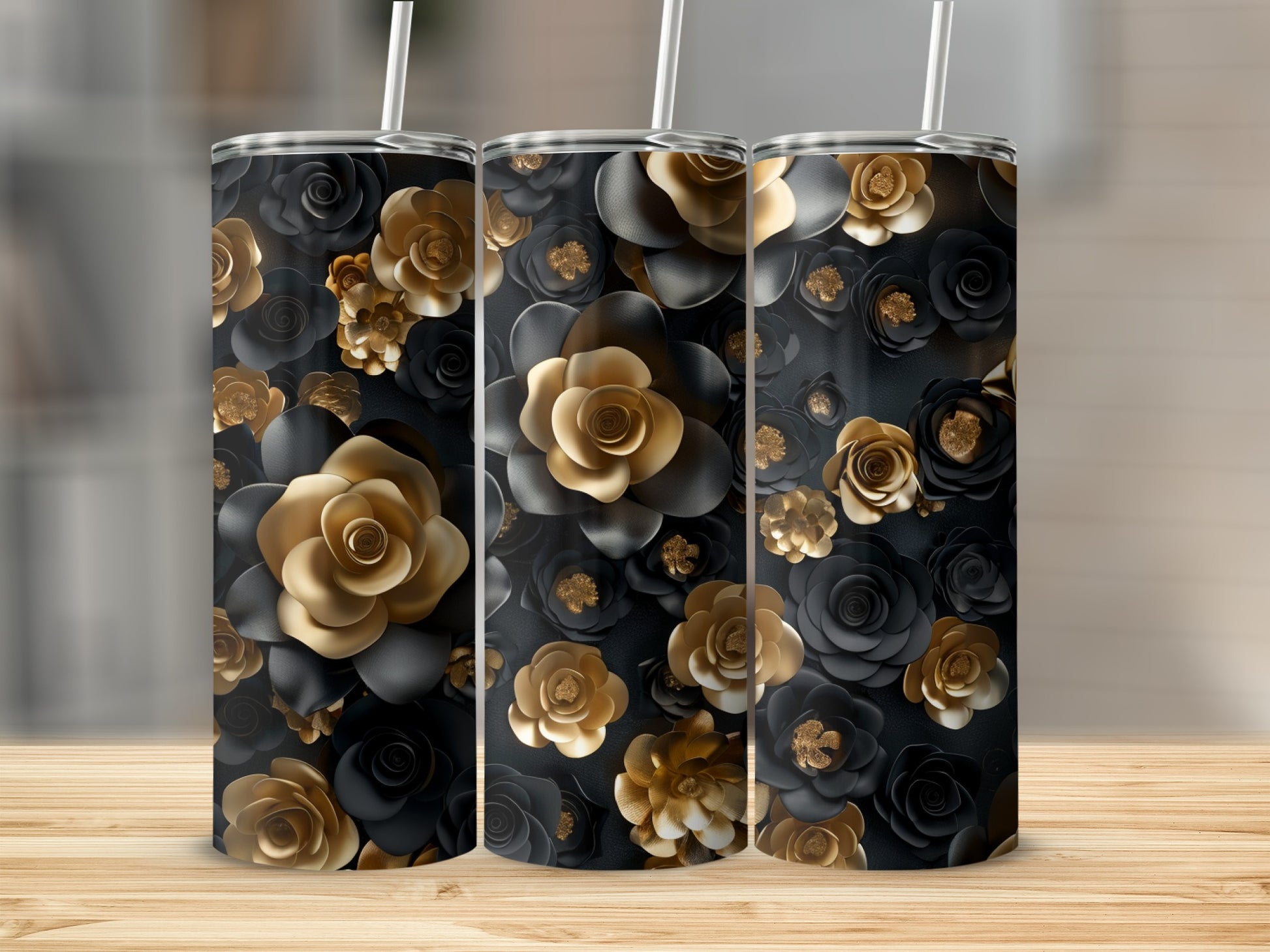 Three tumblers with black and gold floral patterns and straws.