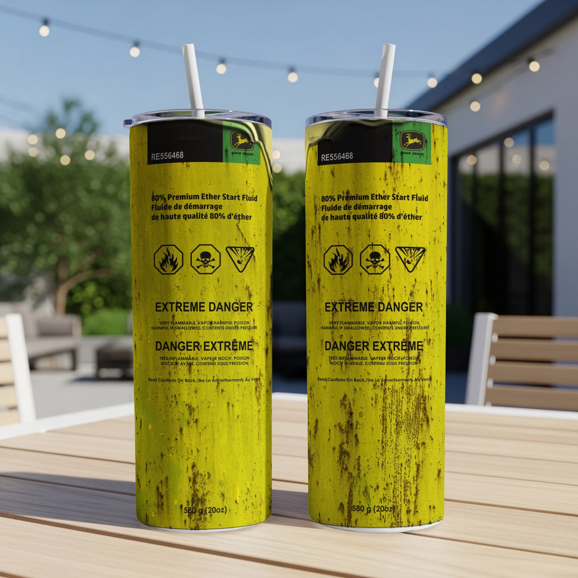 Two yellow John Deere ether starter fluid cans with hazard warnings.