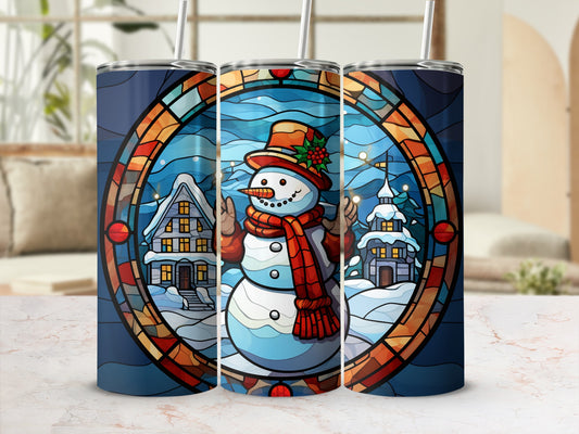 Stained glass tumbler with snowman and winter village design.