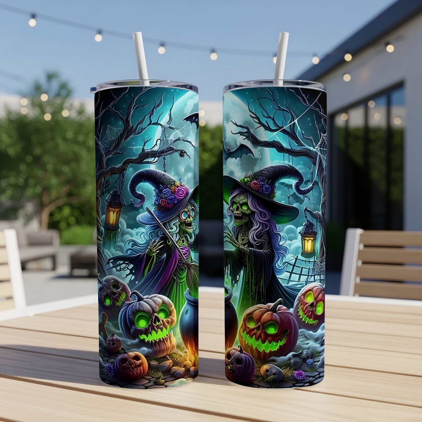Two Halloween tumblers with witches, jack-o'-lanterns, and spooky trees on a table.