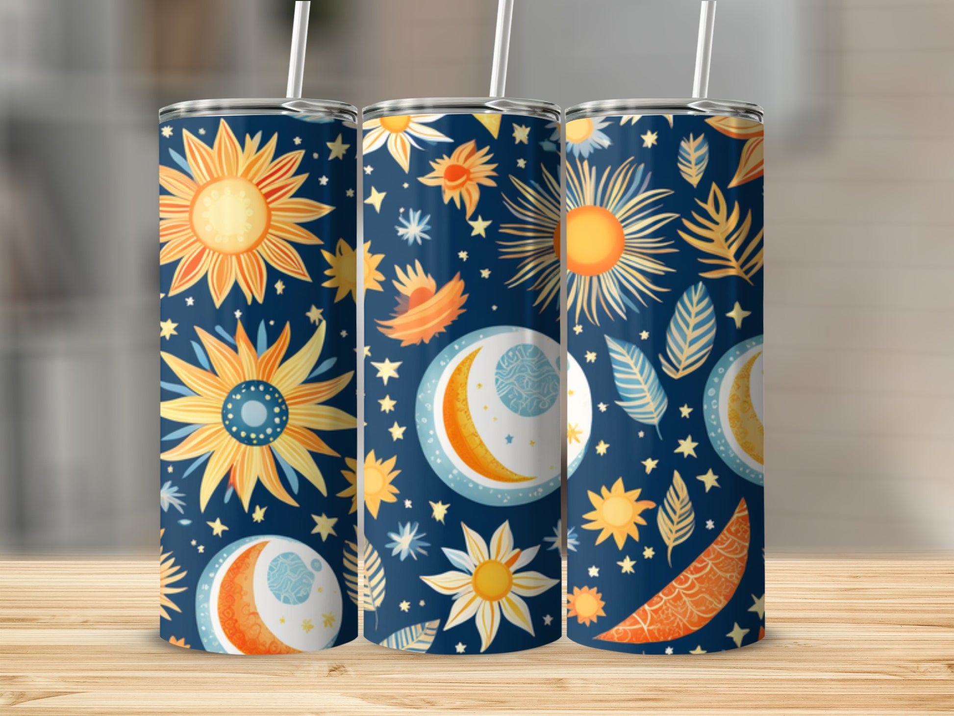 Three tall tumblers with suns, moons, and celestial patterns.