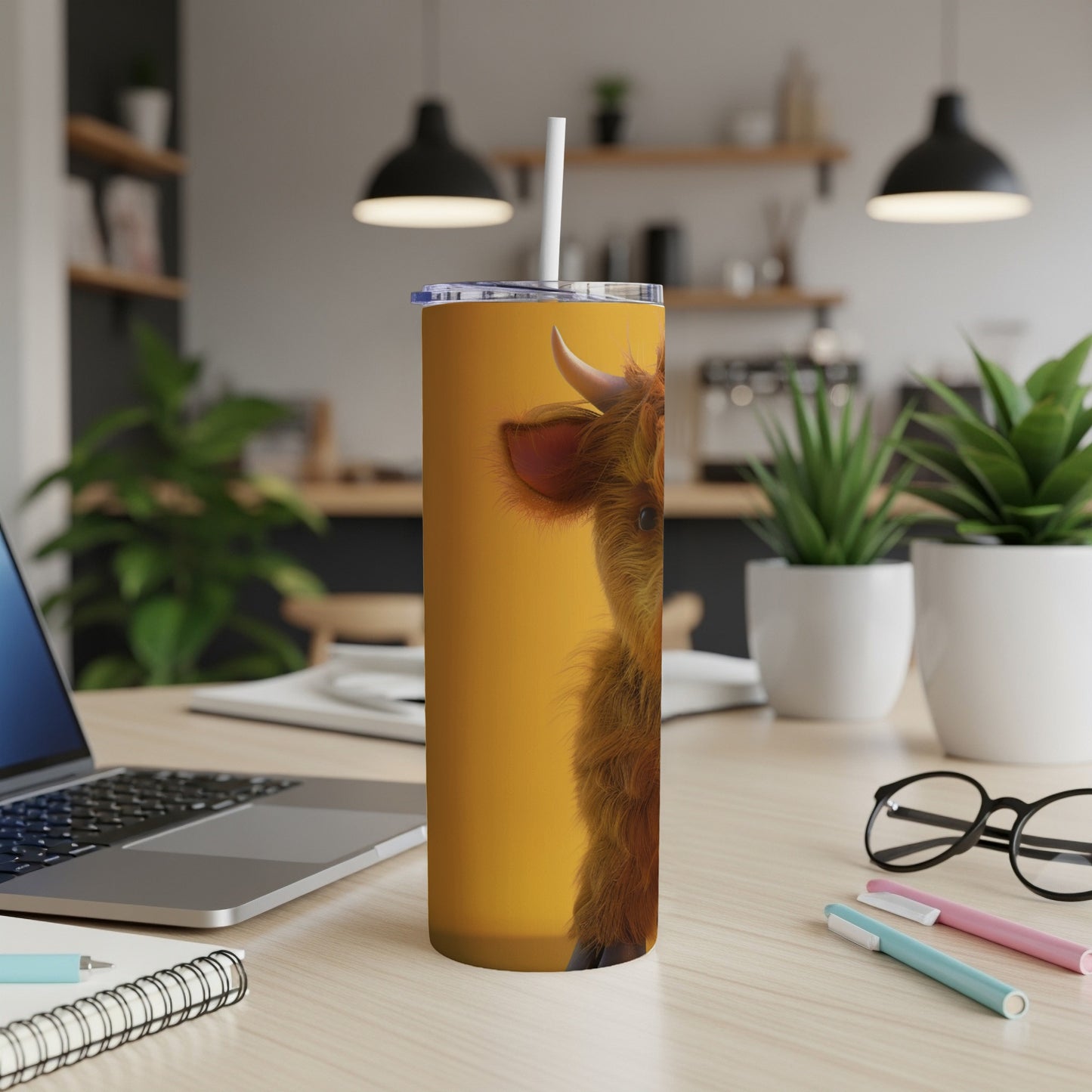 Highland cow face on a yellow tumbler with a straw.