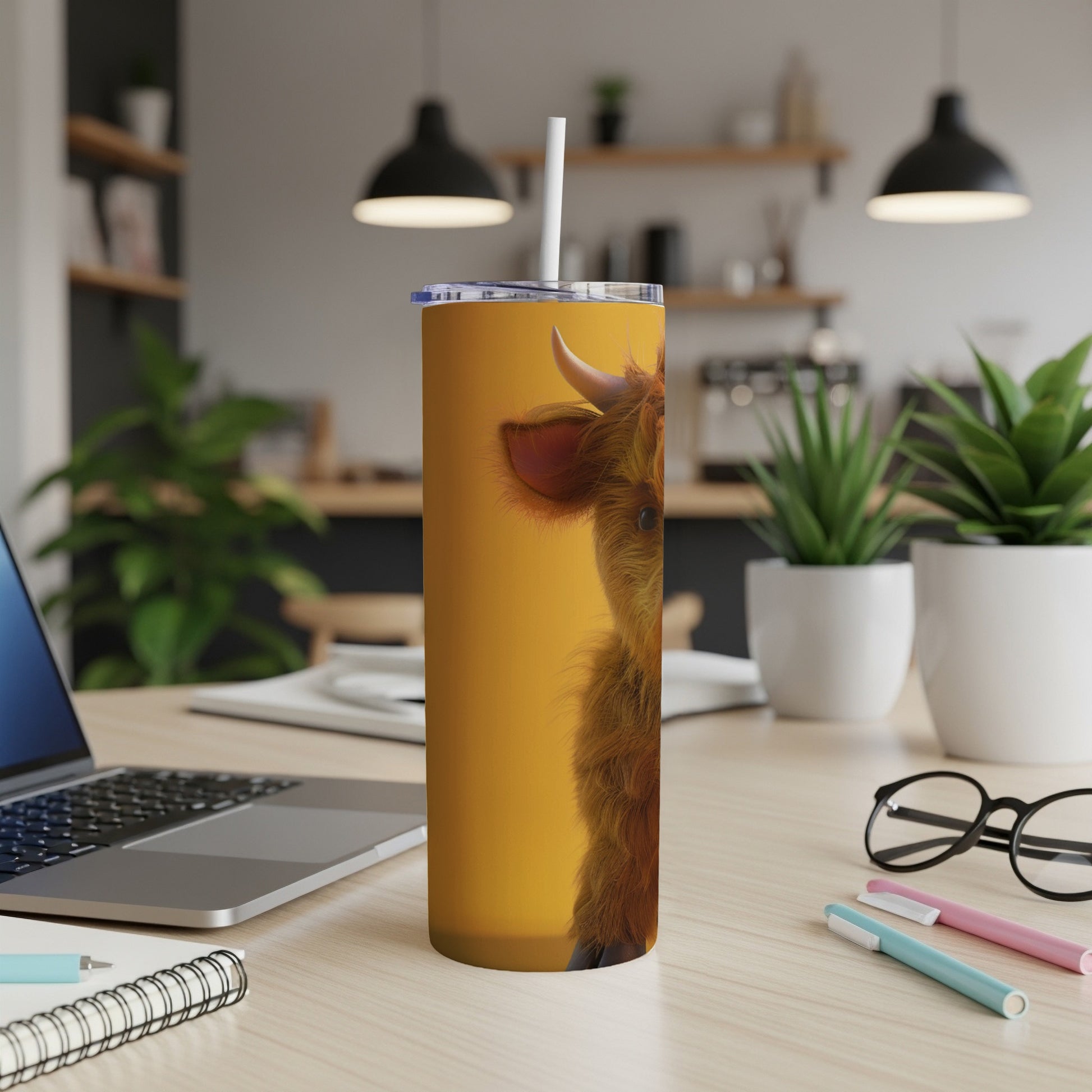 Highland cow face on a yellow tumbler with a straw.