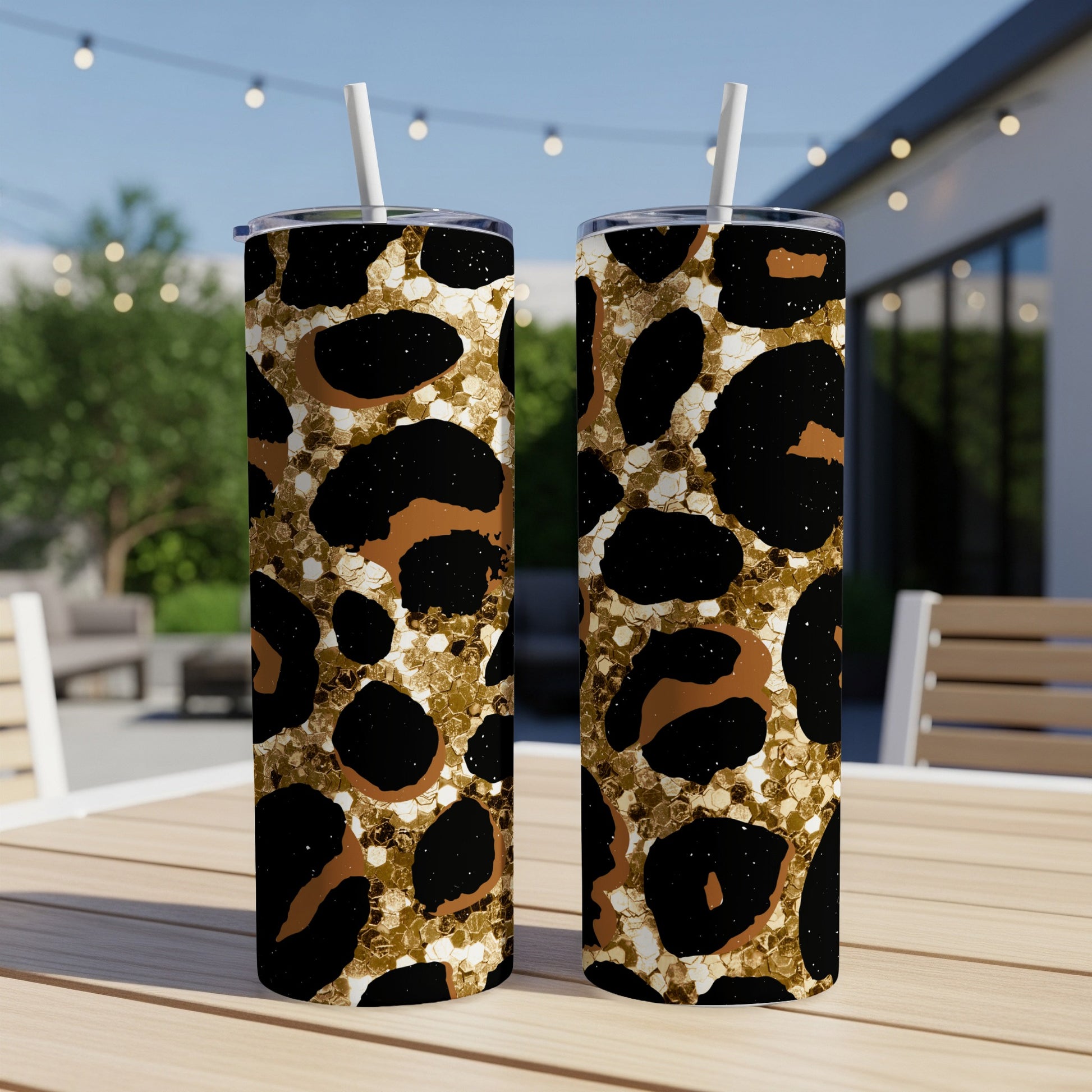 Two tall tumblers with a black and gold leopard print pattern.
