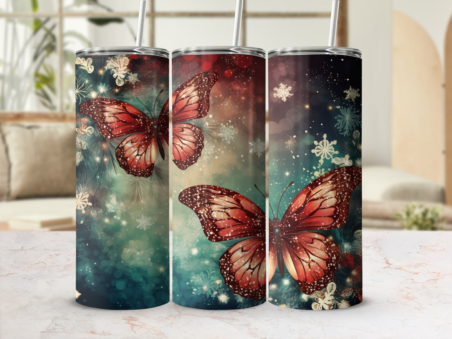 Three tumblers with red butterflies and snowflakes on a dark, bokeh background.