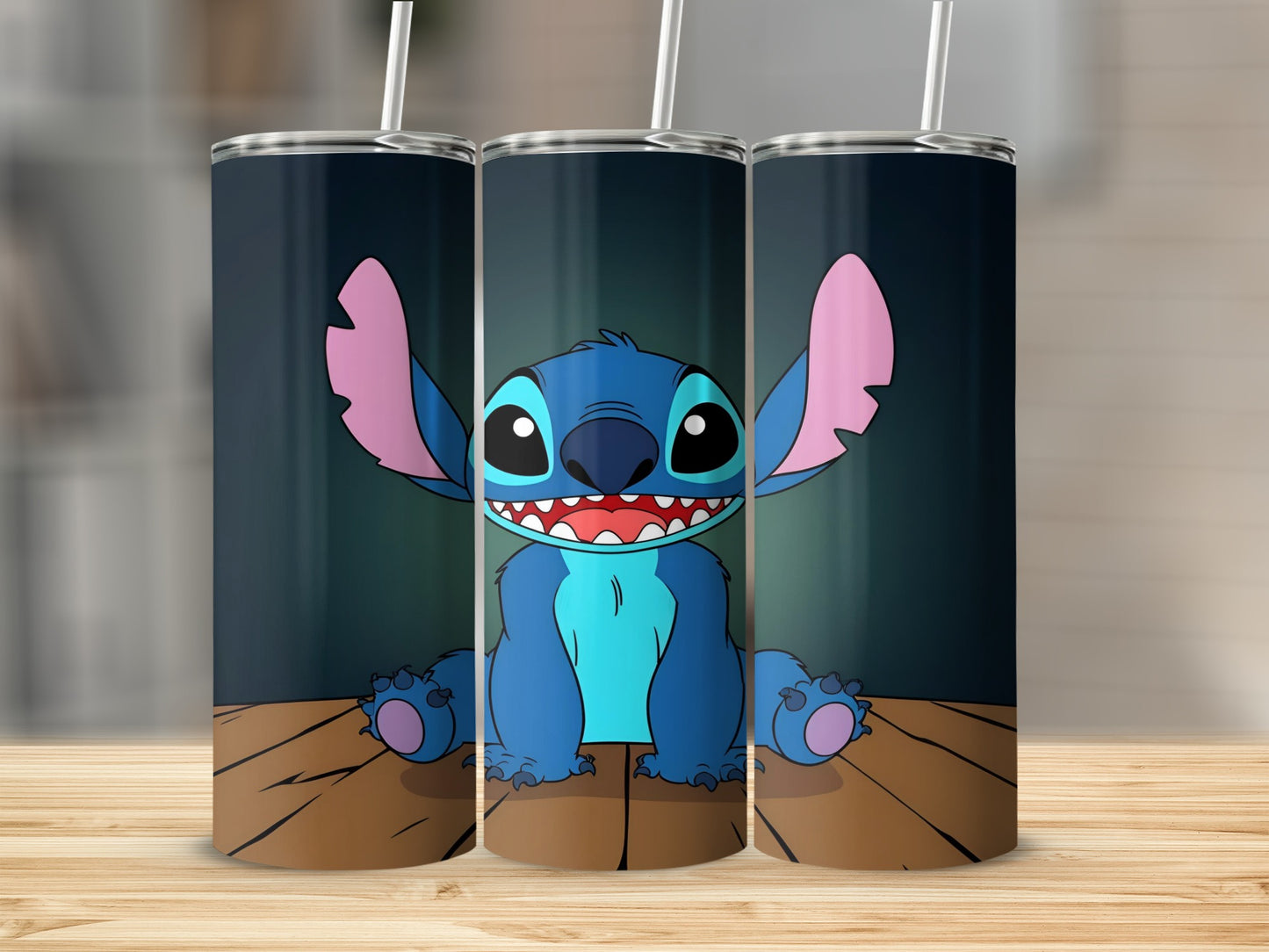 Three tumblers with Stitch character design on wooden surface.