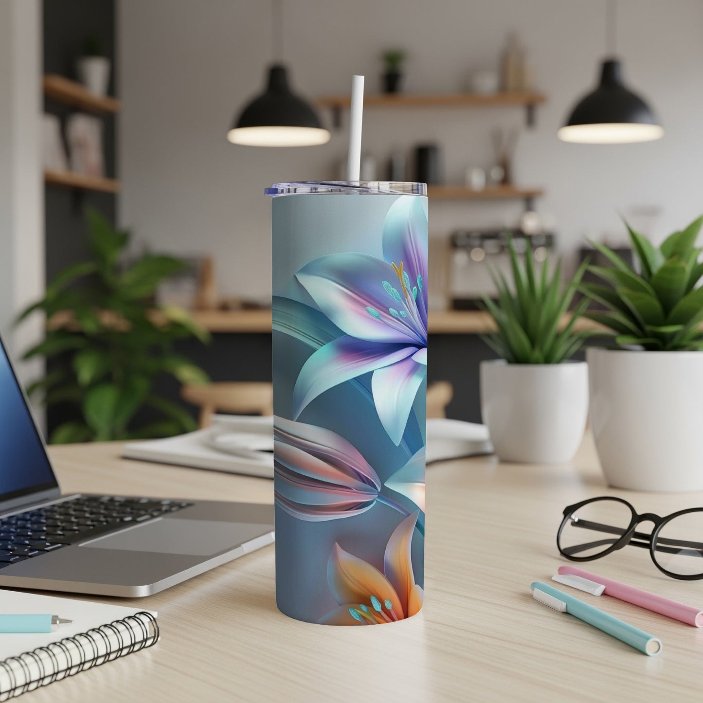 Tall floral-patterned tumbler with a white straw on a desk.