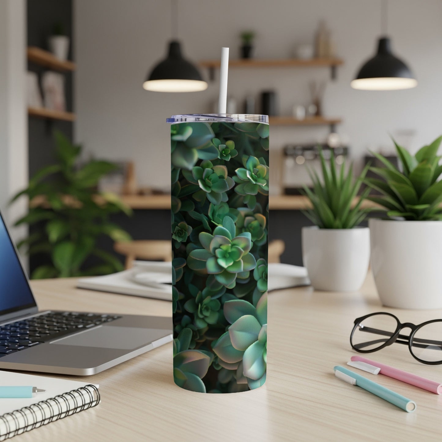 Green succulent plant pattern on a white tumbler with a straw.