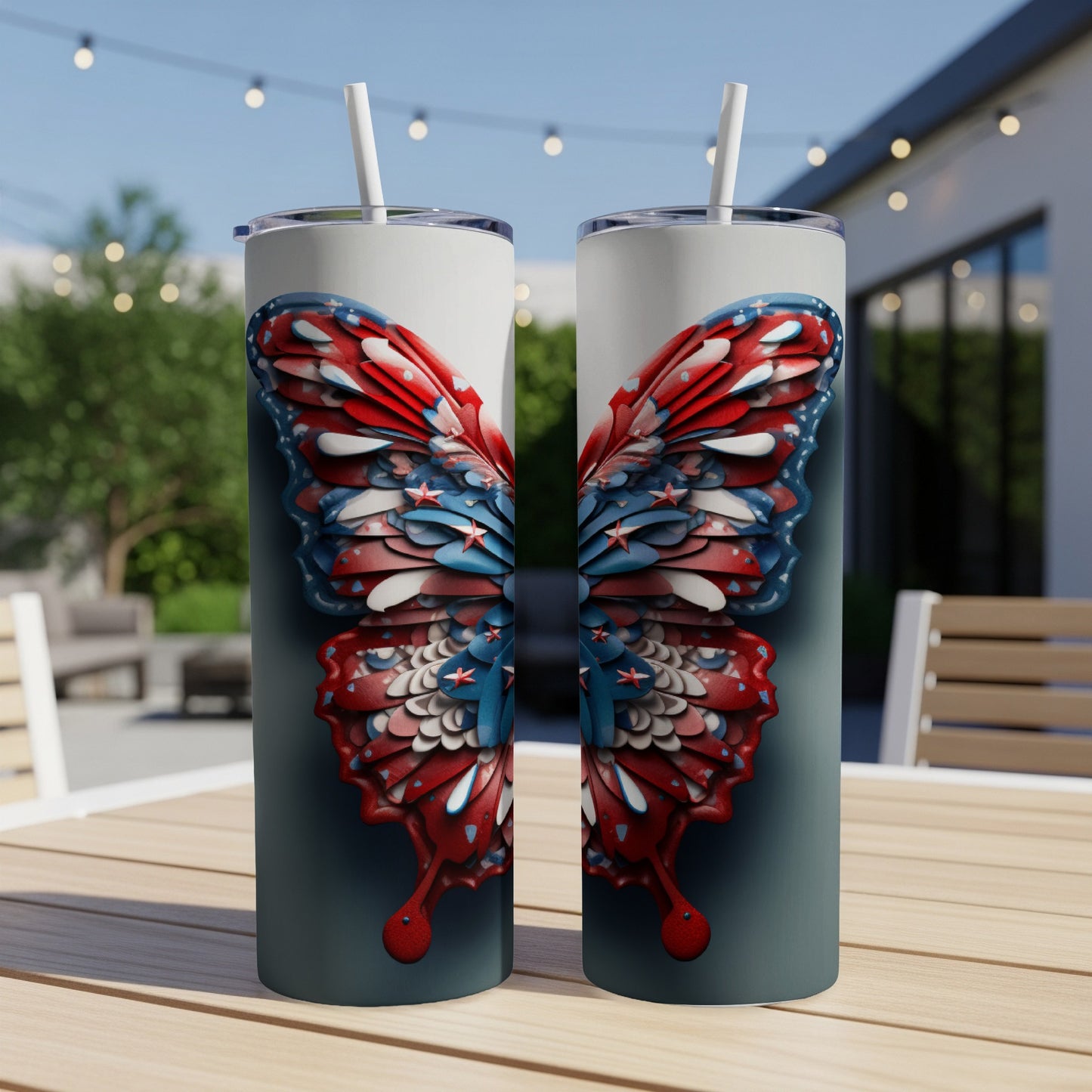 Two tumblers with a patriotic butterfly design sit on a table outdoors.