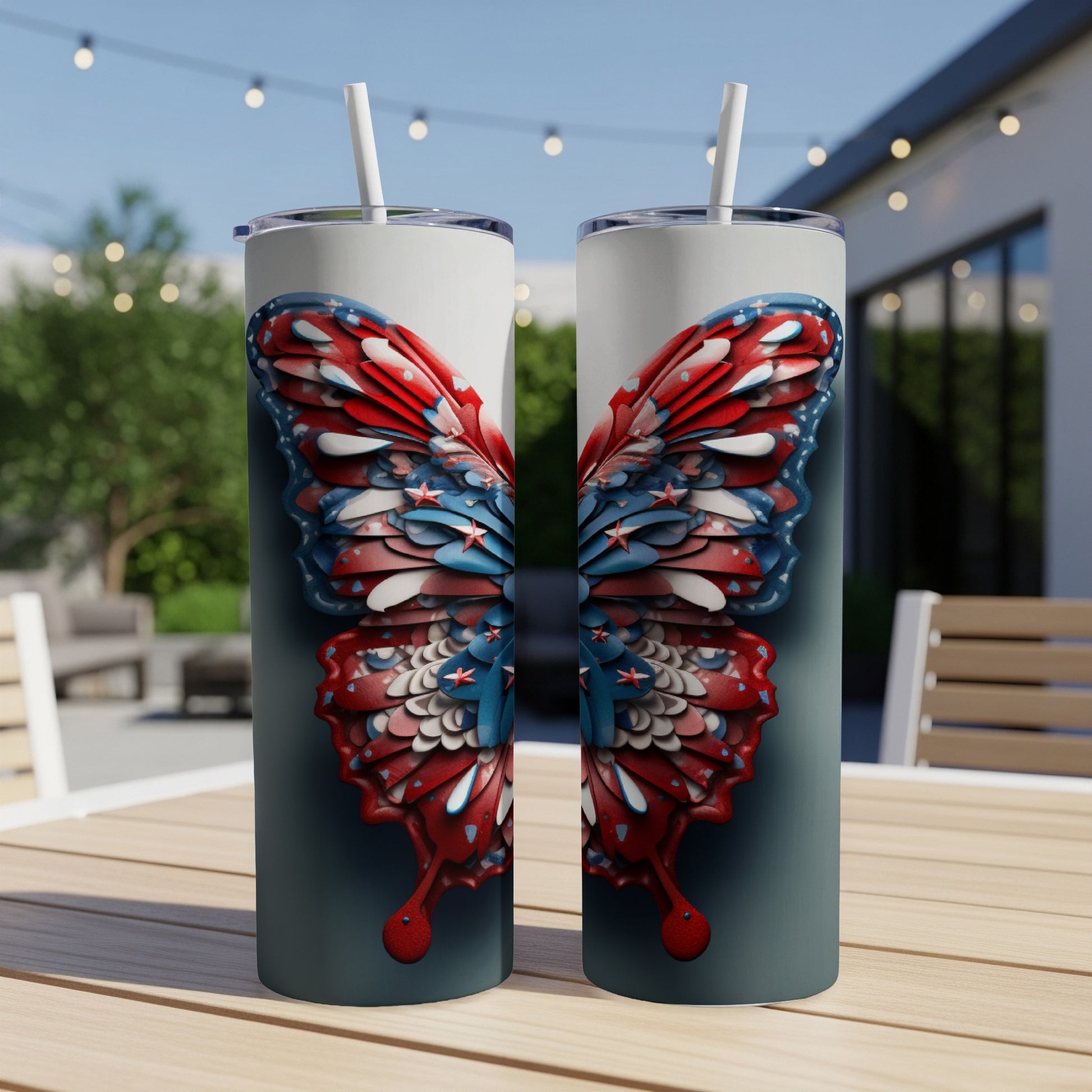 Two tumblers with a patriotic butterfly design sit on a table outdoors.