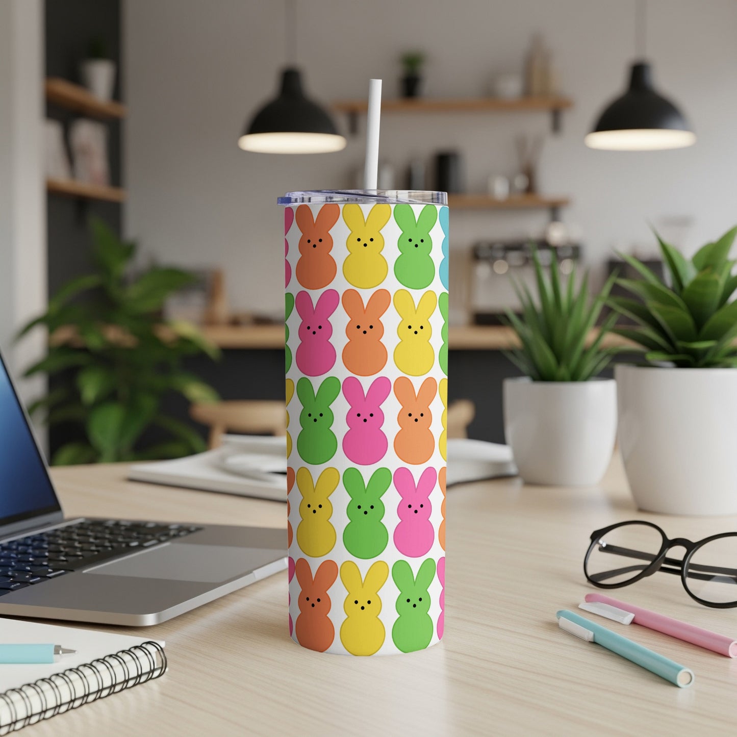 Colorful Easter bunny pattern on a white skinny tumbler with straw.