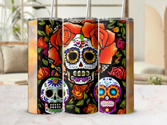 Three tumblers featuring vibrant Day of the Dead skull designs with floral accents.