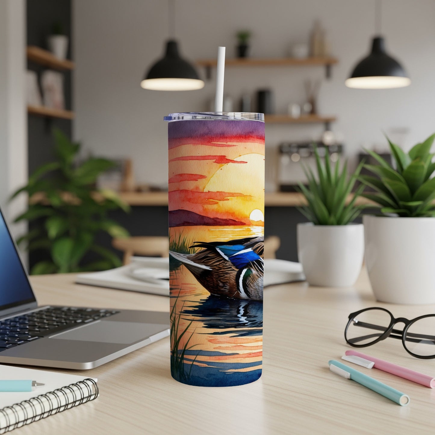 Mallard duck on water with sunset and reeds, on a desk.