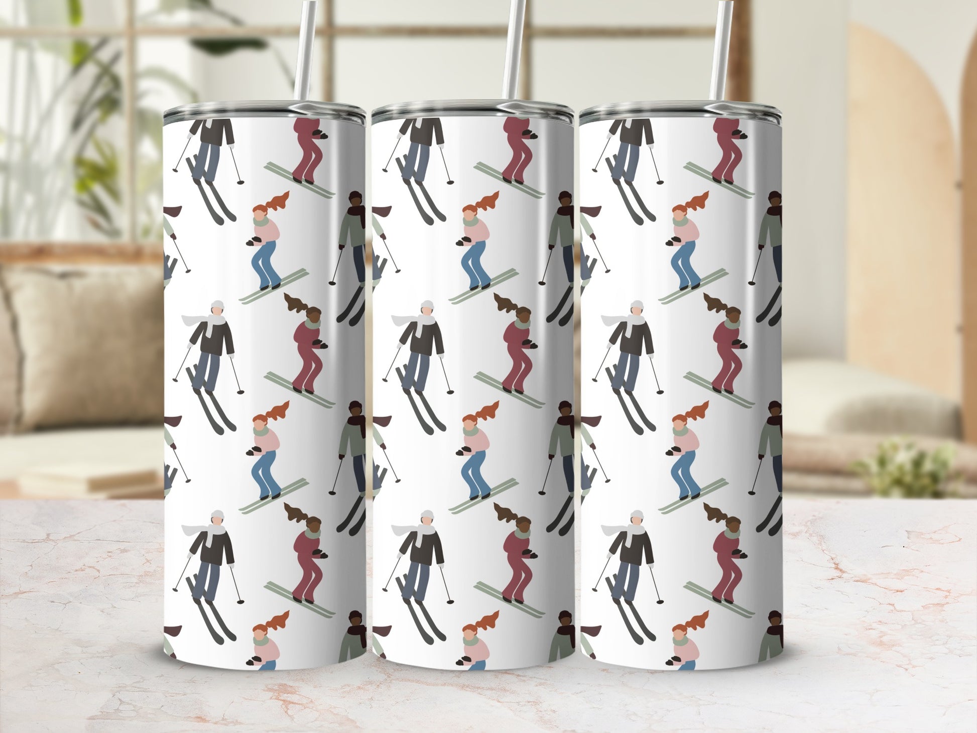 Three tumblers with a repeating pattern of skiers.