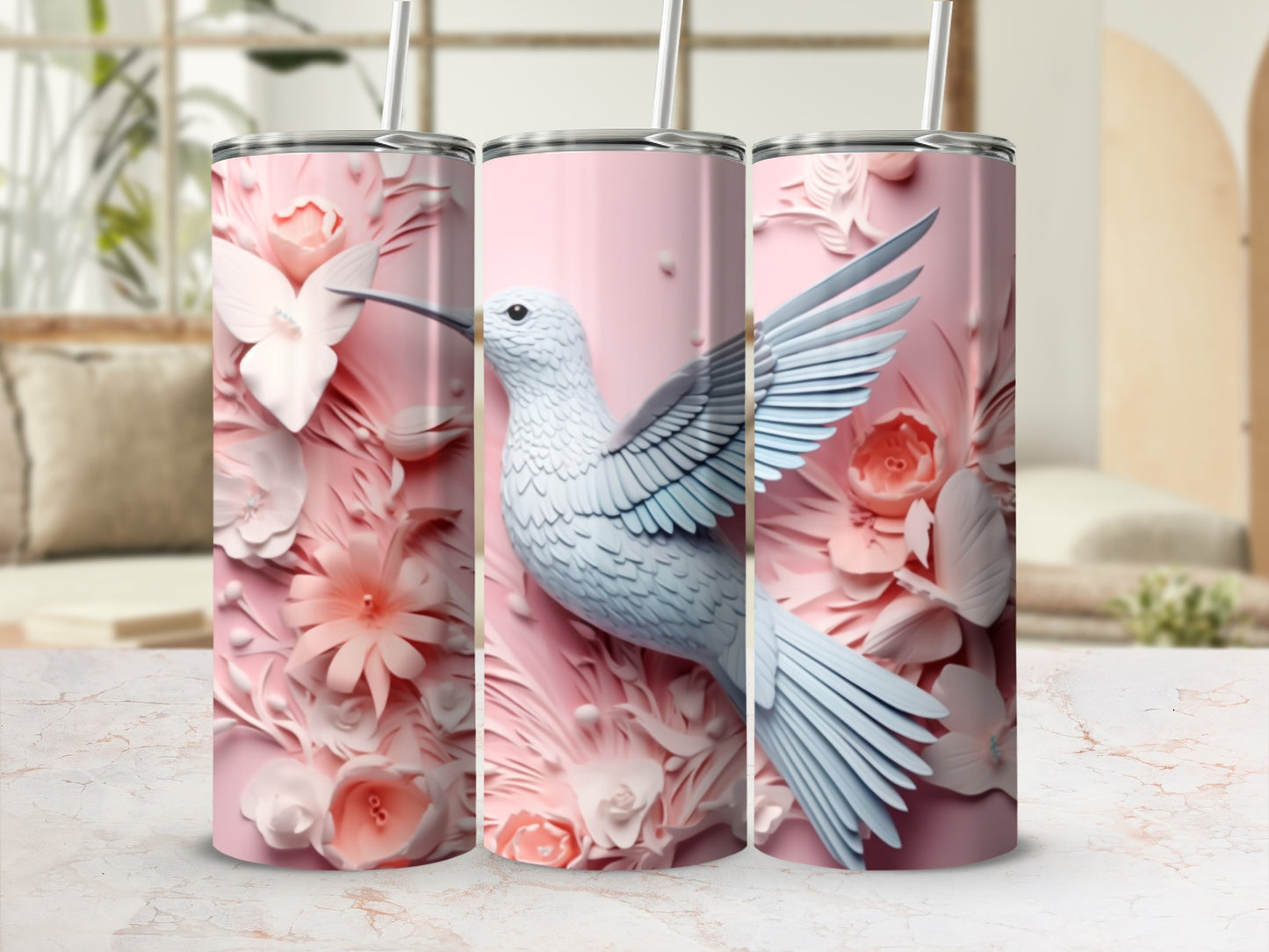 Pink tumbler with a white hummingbird and floral designs.