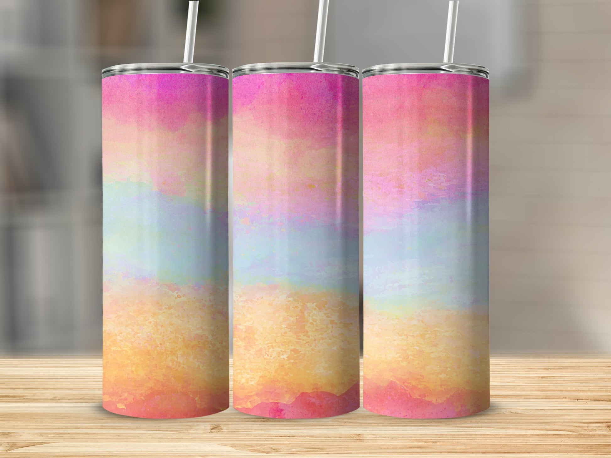 Three tumblers with pastel watercolor paint strokes of pink, yellow, and blue.
