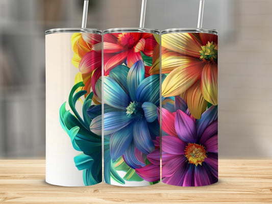 Three colorful floral tumblers with straws arranged in a row.