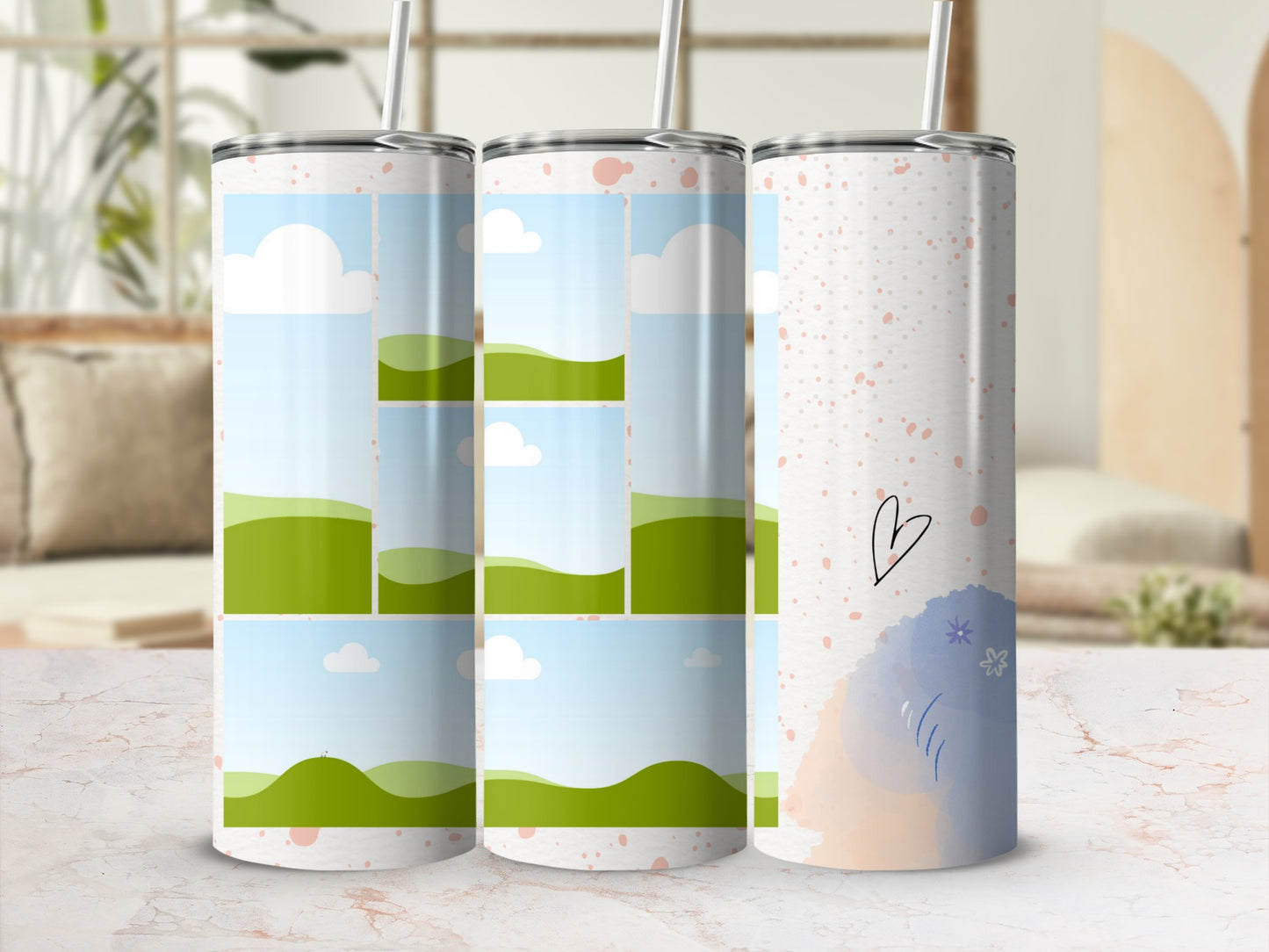 Tumblers with sky and rolling green hill designs, one with a heart and floral accents.