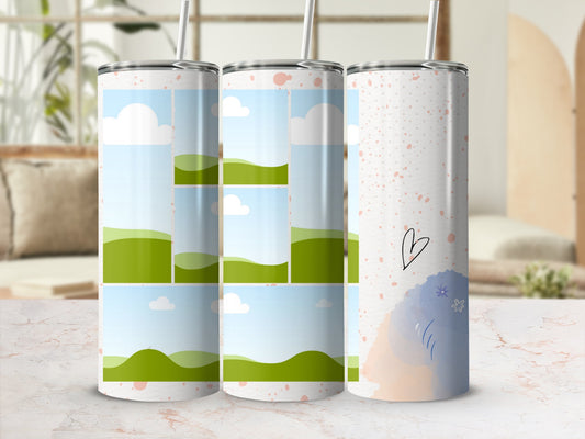 Tumblers with sky and rolling green hill designs, one with a heart and floral accents.
