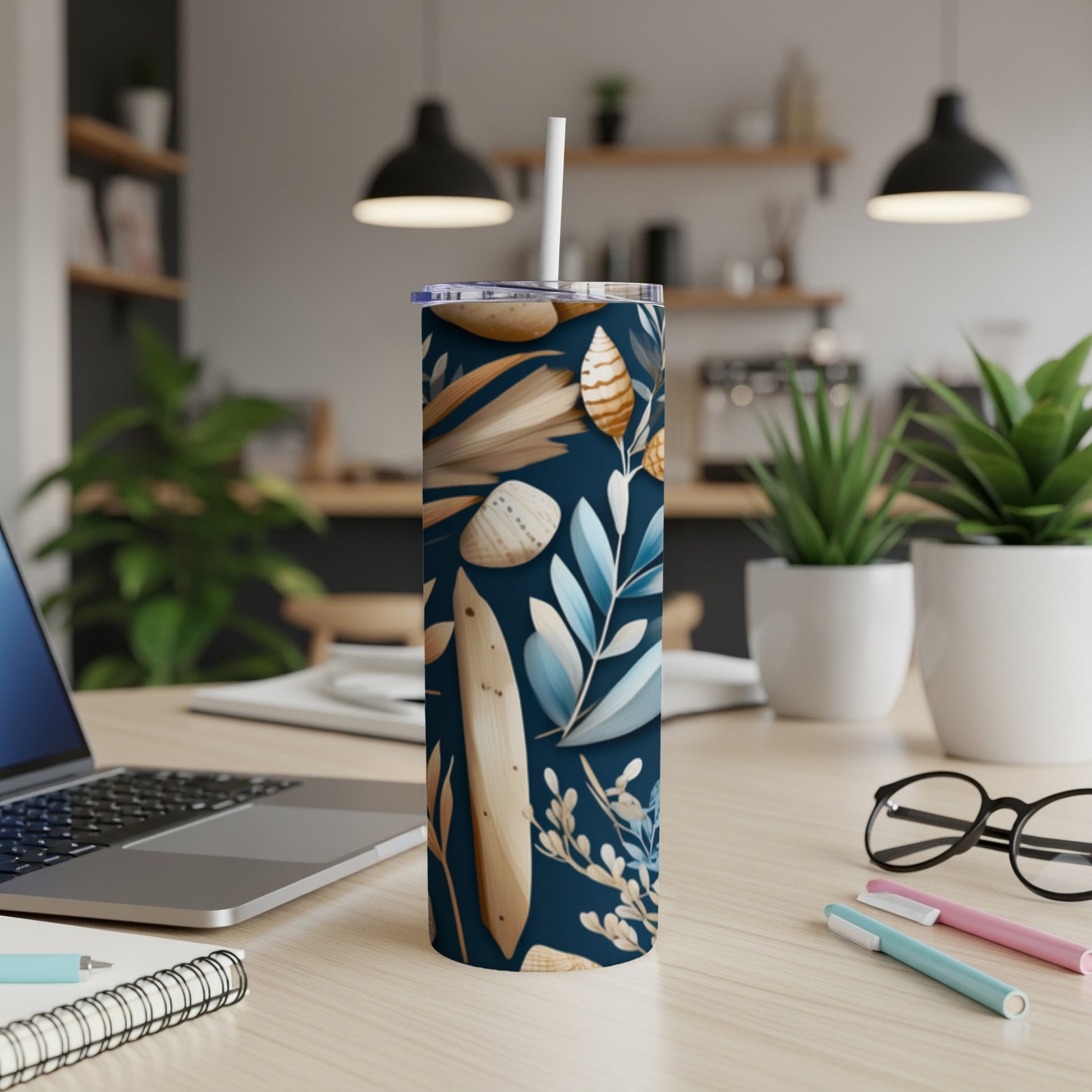 Tall tumbler with a dark blue seashell and leaf pattern.