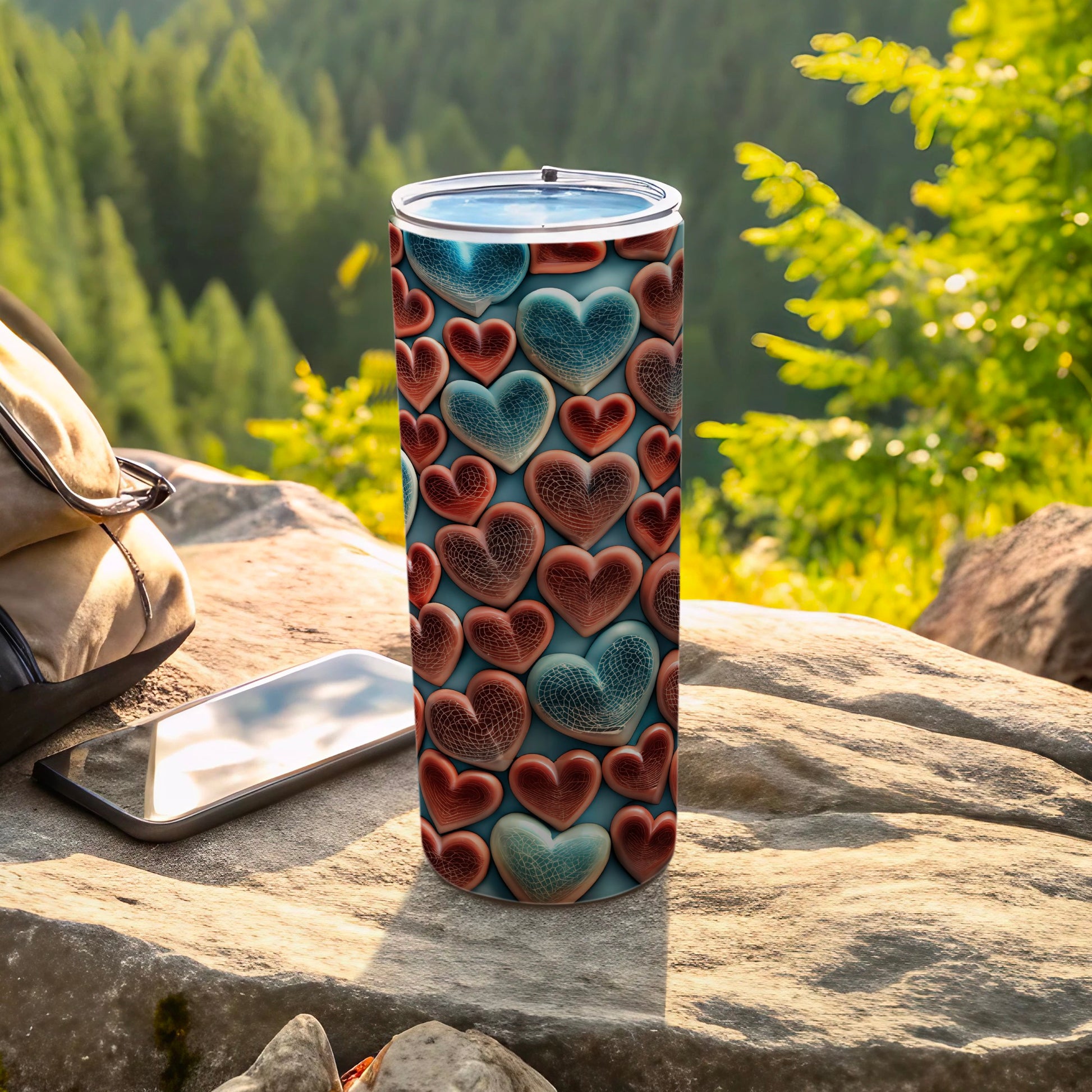 Tumbler with repeating textured heart pattern on a rocky outcrop.