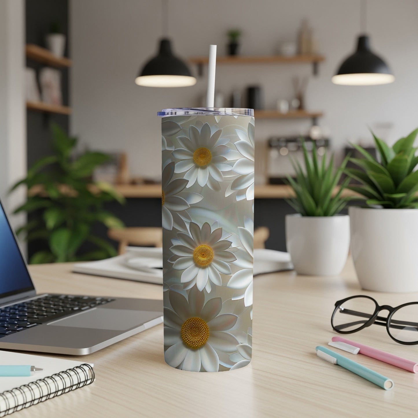 White daisy pattern on a stainless steel tumbler with a straw.