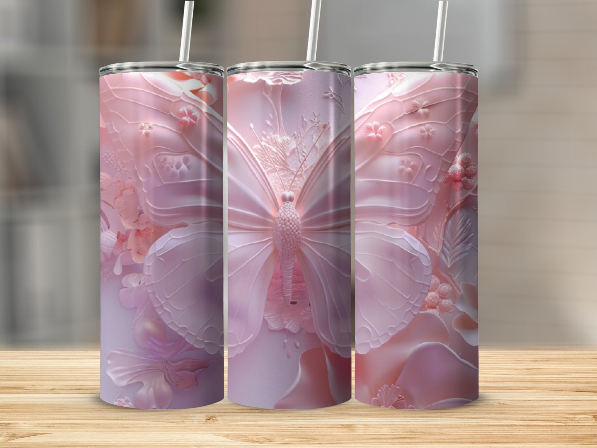Three pink tumblers with intricate butterfly and floral embossed designs.