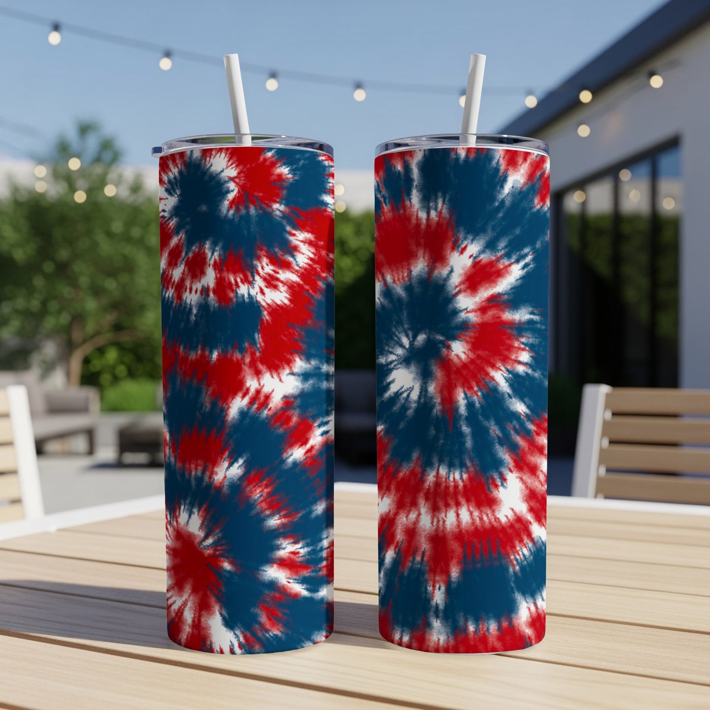 Two tumblers with red, white, and blue tie-dye patterns on a wooden table.