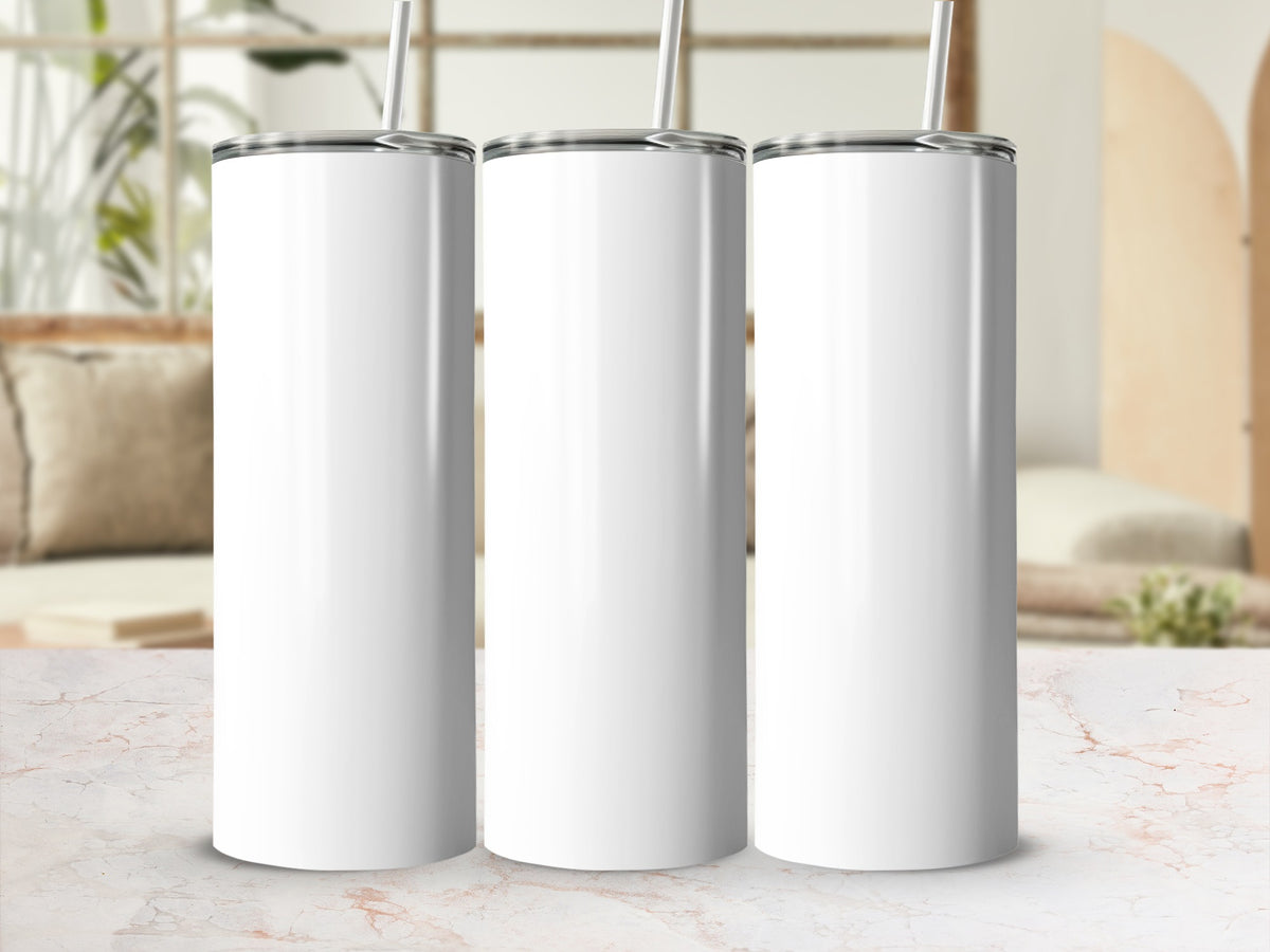 Three blank white tumblers with metal lids and straws arranged side-by-side.